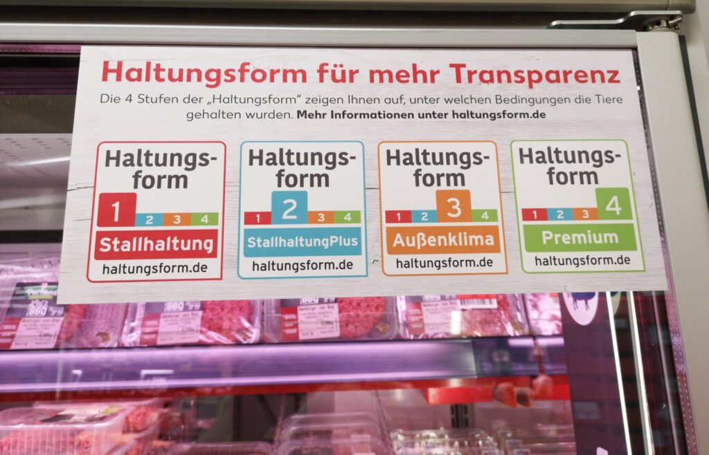 Foto von einem Kühlschrank mit abgepacktem Fleisch im Supermarkt mit Erklärungstafel der "Haltungsform für mehr Transparenz"